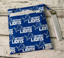 Load image into Gallery viewer, Blue and gray Detroit Lions pattern travel diaper bag with key FOB and changing pad.