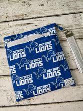 Load image into Gallery viewer, Blue and gray Detroit Lions pattern travel diaper bag with key FOB and changing pad.