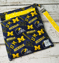 Load image into Gallery viewer, Blue and yellow University of Michigan pattern travel diaper bag with key FOB and changing pad.