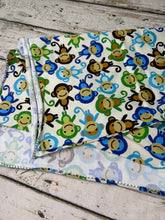 Load image into Gallery viewer, Swaddle blanket with sock monkey print in green and blue