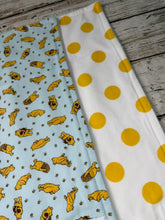 Load image into Gallery viewer, Close up of Set of 2 burp cloths. One is blue with yellow Winnie Pooh. Other is white with large yellow polka dots.