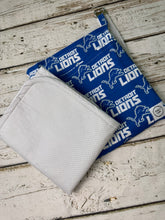 Load image into Gallery viewer, Blue and gray Detroit Lions pattern travel diaper bag with key FOB and changing pad.
