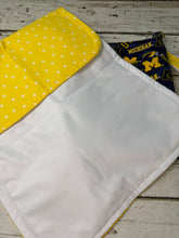 Load image into Gallery viewer, Blue and yellow University of Michigan pattern travel diaper bag with key FOB and changing pad.
