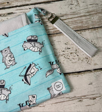 Load image into Gallery viewer, A fabric diaper bag pouch with a light blue and white striped pattern featuring bears shown on a rustic white-washed wooden background.
