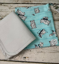 Load image into Gallery viewer, A fabric diaper bag pouch with a light blue and white striped pattern featuring bears shown on a rustic white-washed wooden background.
