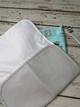 Load image into Gallery viewer, A fabric diaper bag pouch with a light blue and white striped pattern featuring bears shown on a rustic white-washed wooden background.
