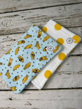 Load image into Gallery viewer, Set of 2 burp cloths.  One is blue with yellow Winnie Pooh.  Other is white with large yellow polka dots.

