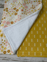 Load image into Gallery viewer, two burp cloths for baby girl with boho pink and gold flowers. and triangles
